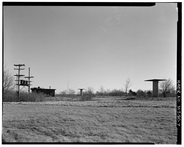 VIEW SOUTHEAST, East Control Area, power poles, generator building, two radar towers