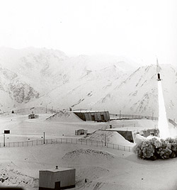 Looking southeast at Site Summit's missile launch site during firing of a missile, 1960